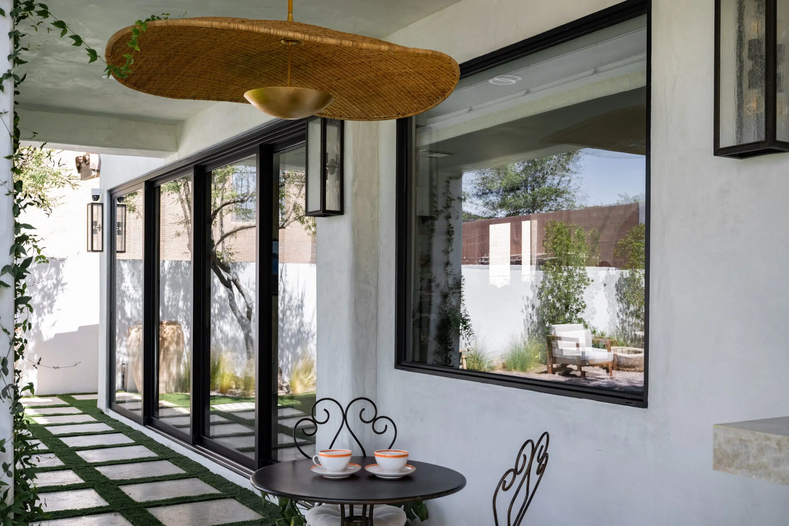 Exterior view of a Las Vegas home featuring a custom Raven sliding door and accordion window, showcasing modern design and seamless indoor-outdoor living.