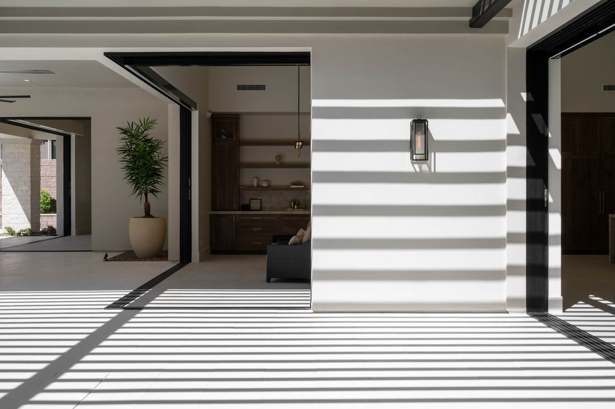 custom-new-build-southern-highlands_kingdomandco Covered patio with outdoor access leading to luxury home office interior.