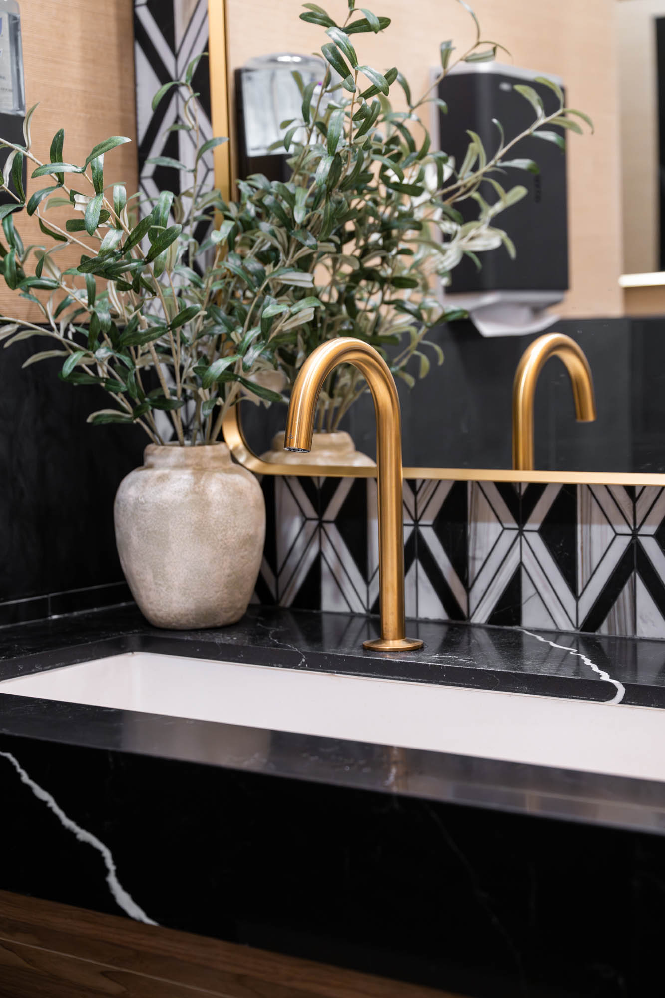 Elegant bathroom with gold faucet.