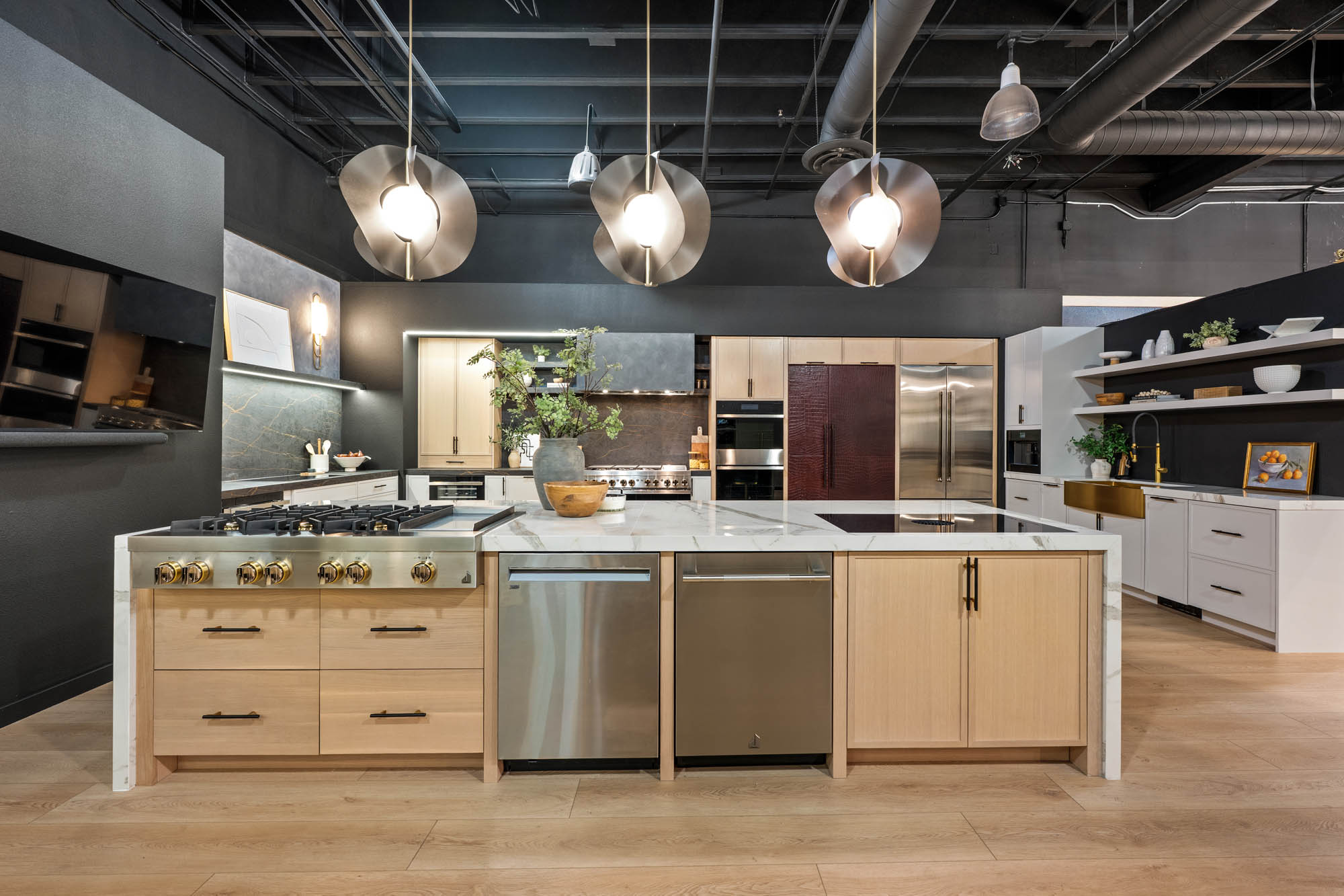 Dual-island kitchen with marble surfaces, brass fixtures, and open shelving designed by Kingdom & Co Las Vegas.