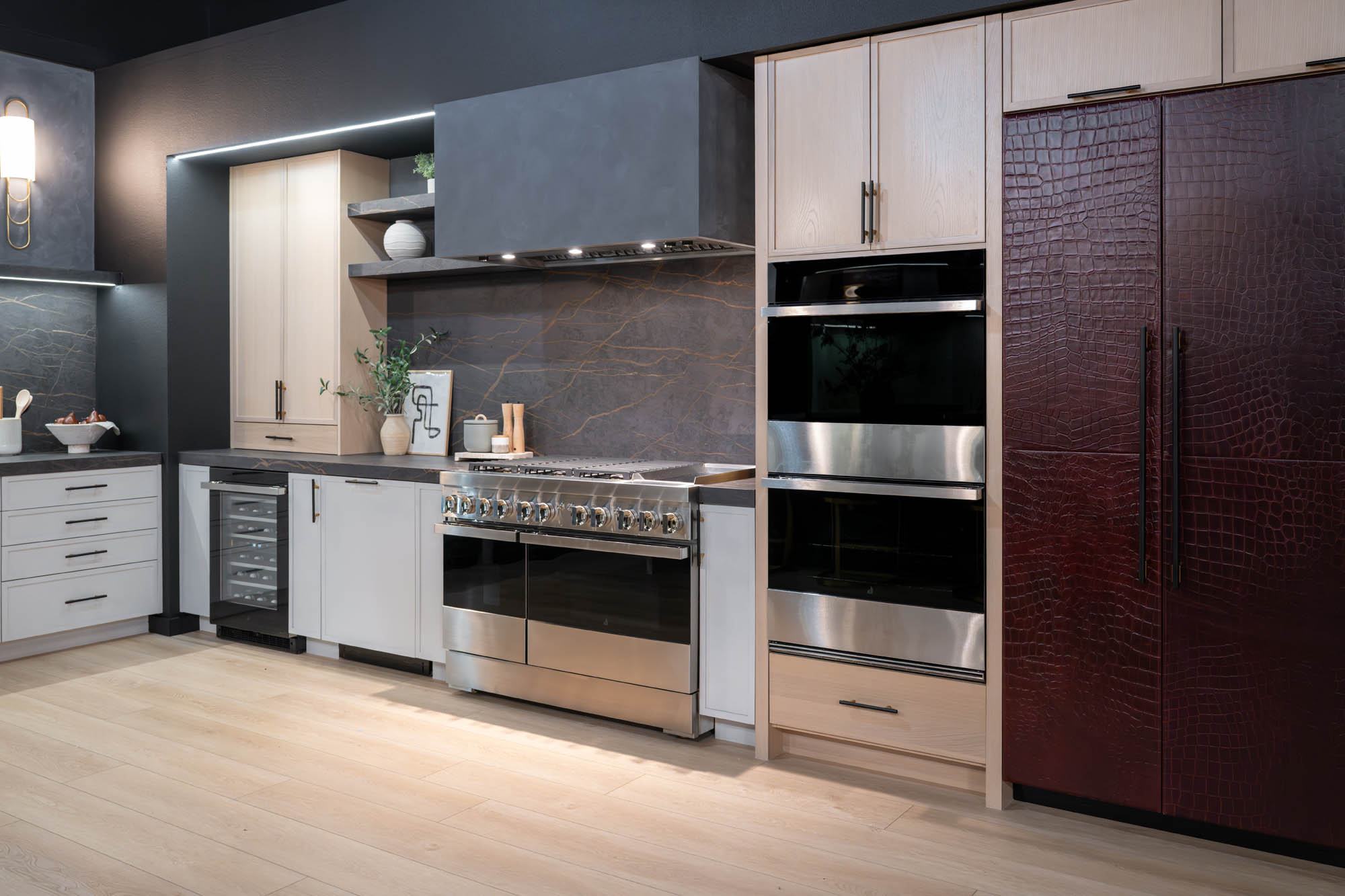 Full view of modern kitchen with marble island, dark backsplash, and custom cabinetry designed by Kingdom & Co Las Vegas.