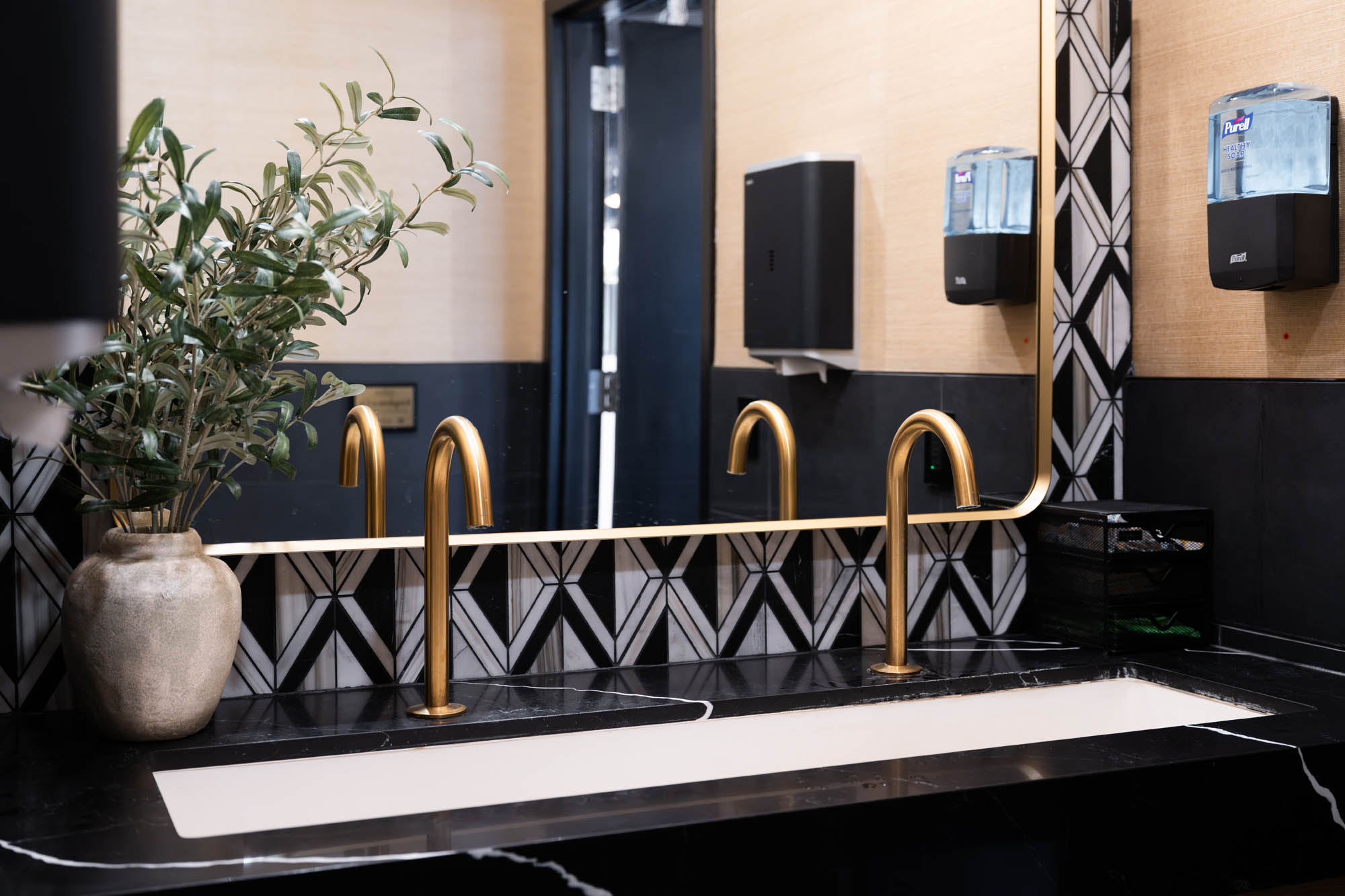 Elegant bathroom with gold fixtures.
