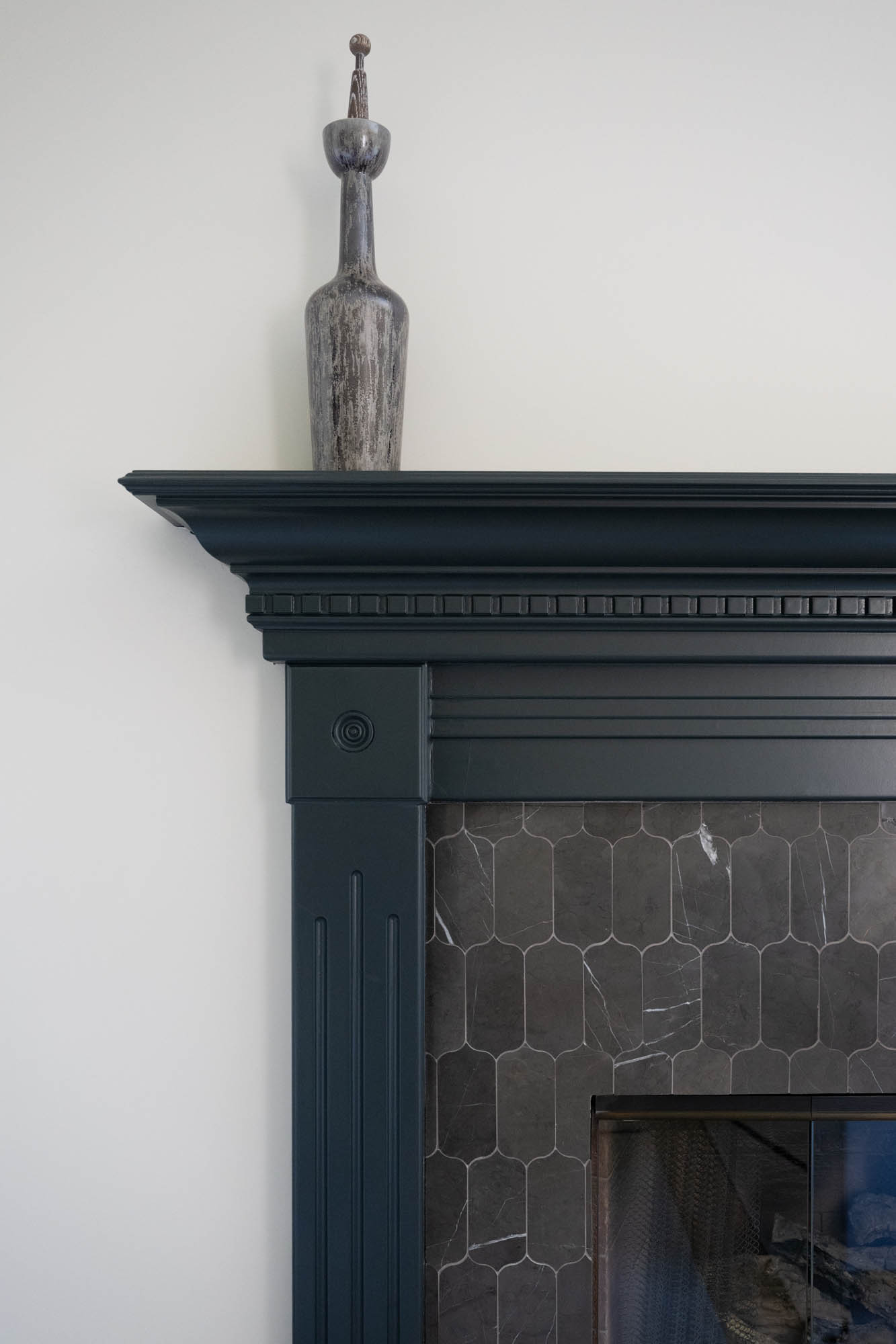 The Lucida_summerlin-south_luxury-remodel_kingdomandco Close-up of dark tile fireplace mantel in a luxury home remodel by Kingdom & Co in Summerlin South.
