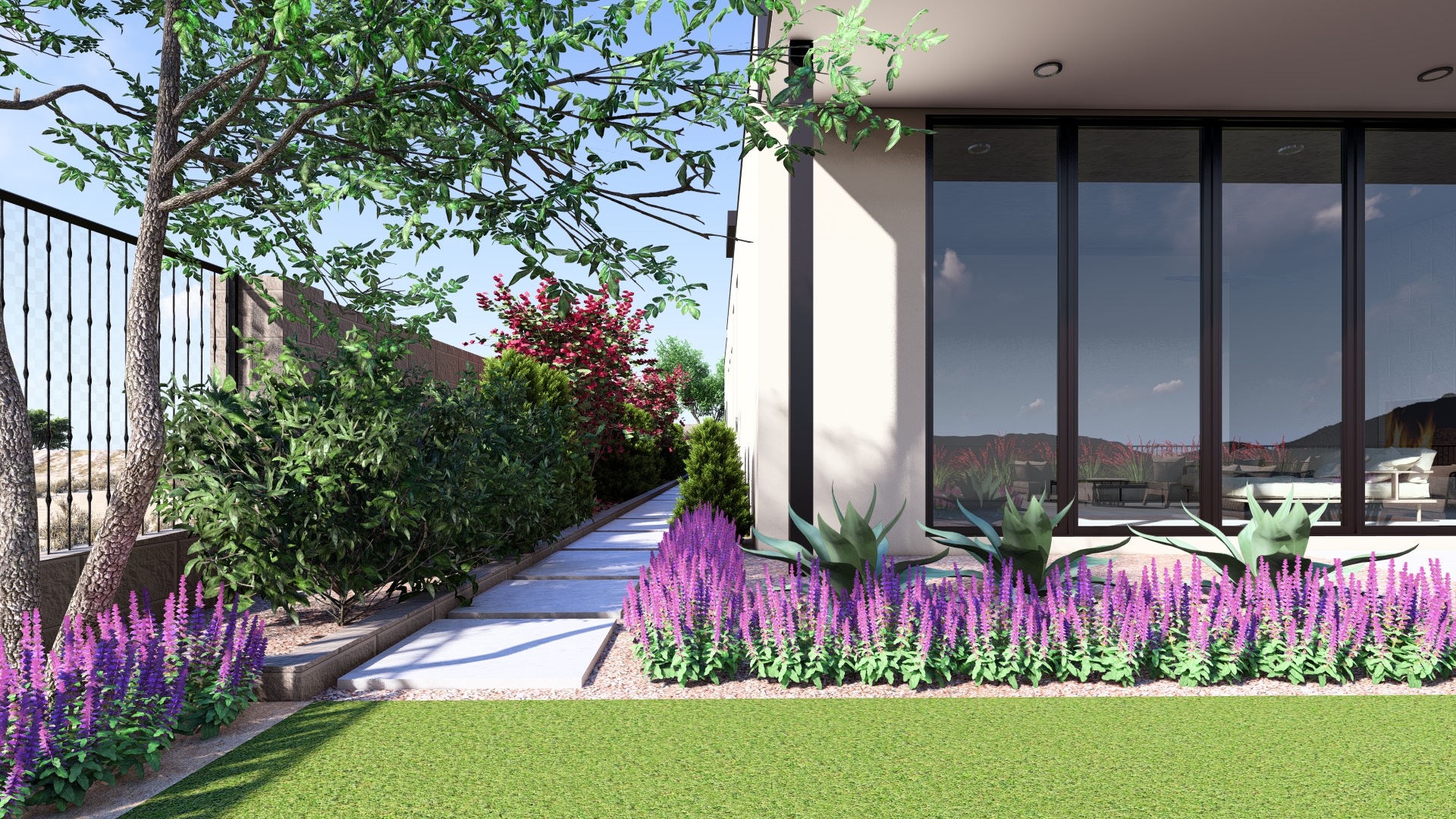 A serene side garden path at a Kingdom & Co. Ascaya home, lined with desert plants, lush greenery, and modern walkway pavers beside large windows.