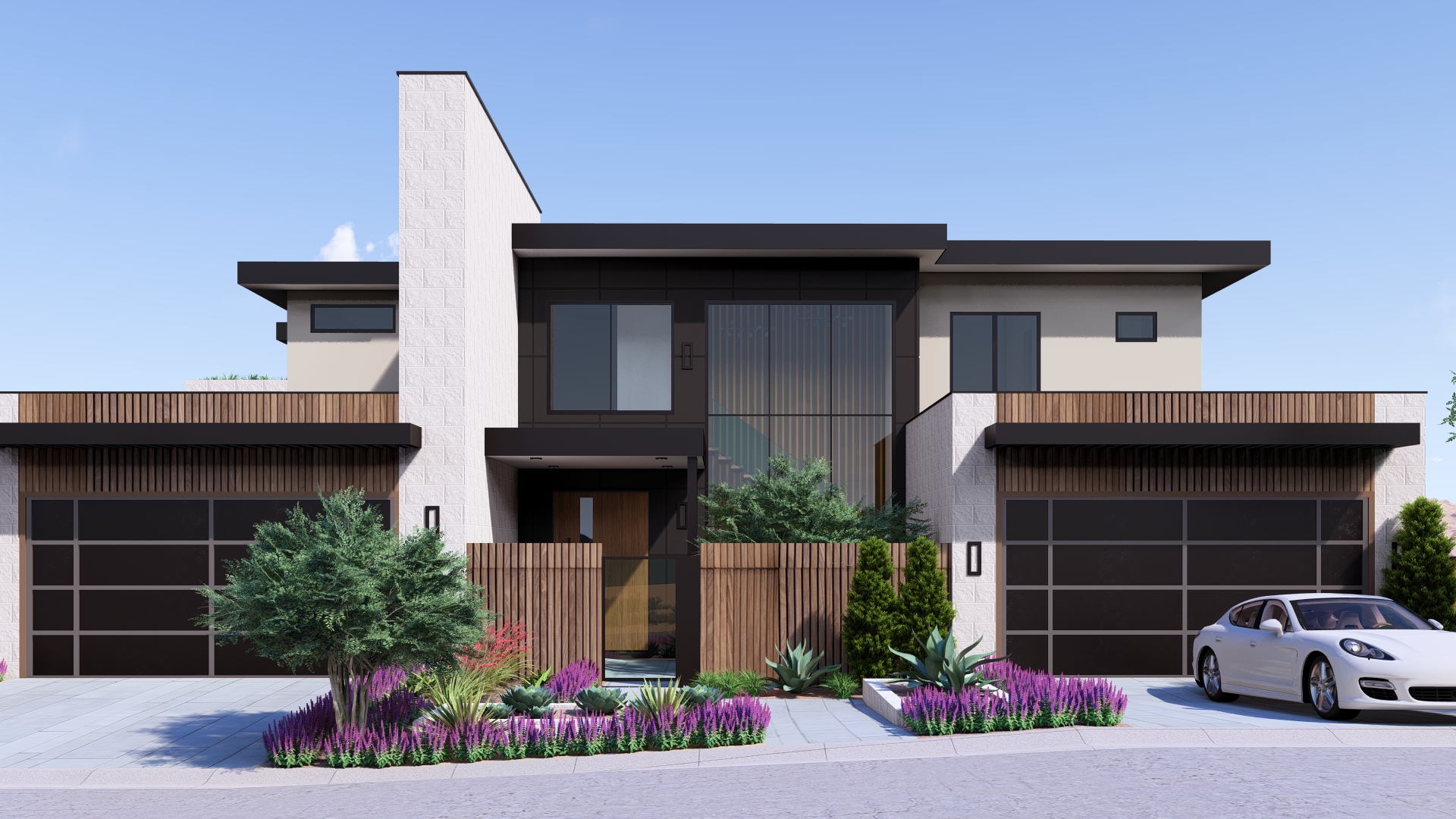 Full front elevation of a modern luxury home in Ascaya featuring glass, stone textures, wood details, and lush desert landscaping.