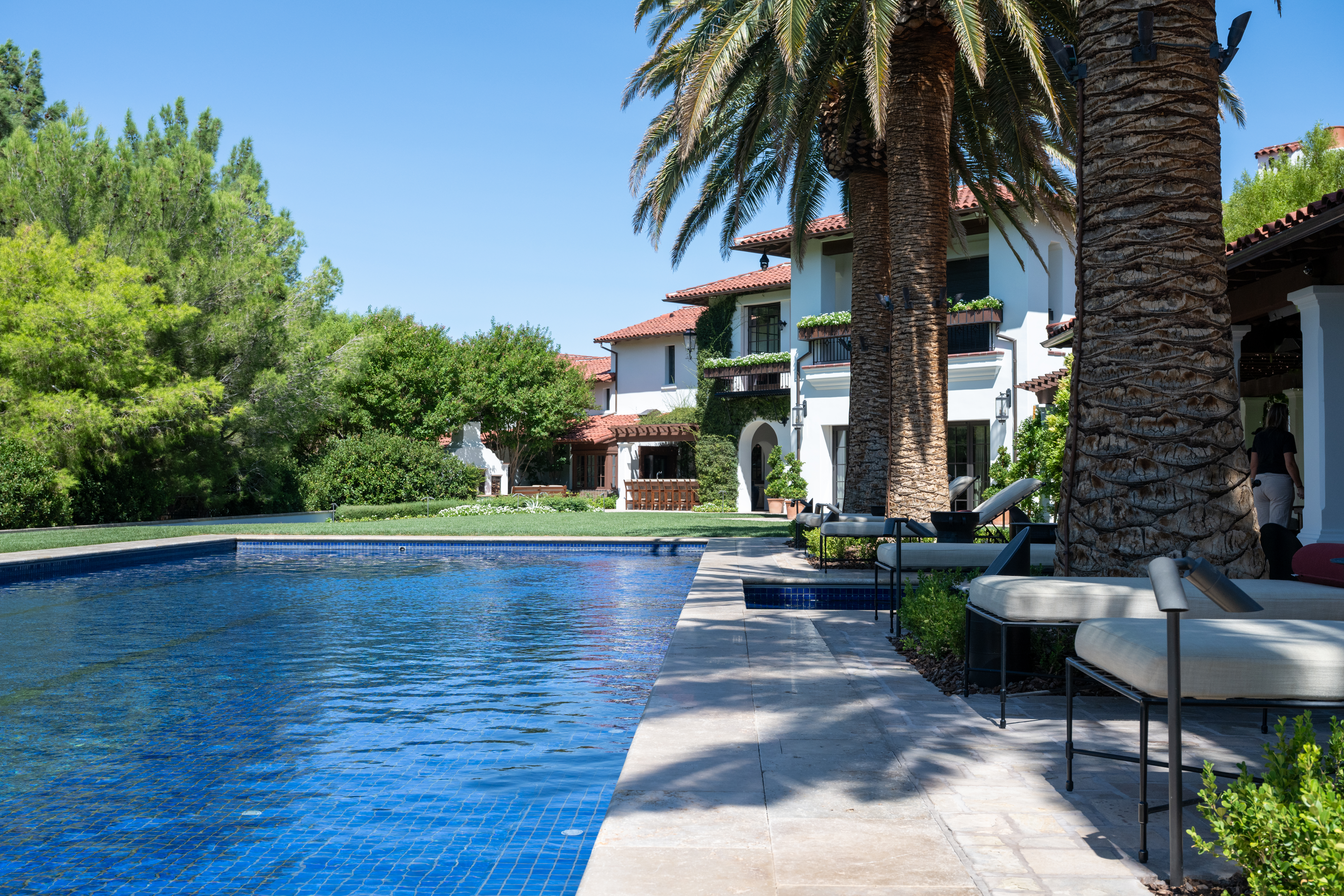 Pool terrace with lounge seating at Santa Barbara Estate in Southern Highlands Las Vegas by Kingdom & Co