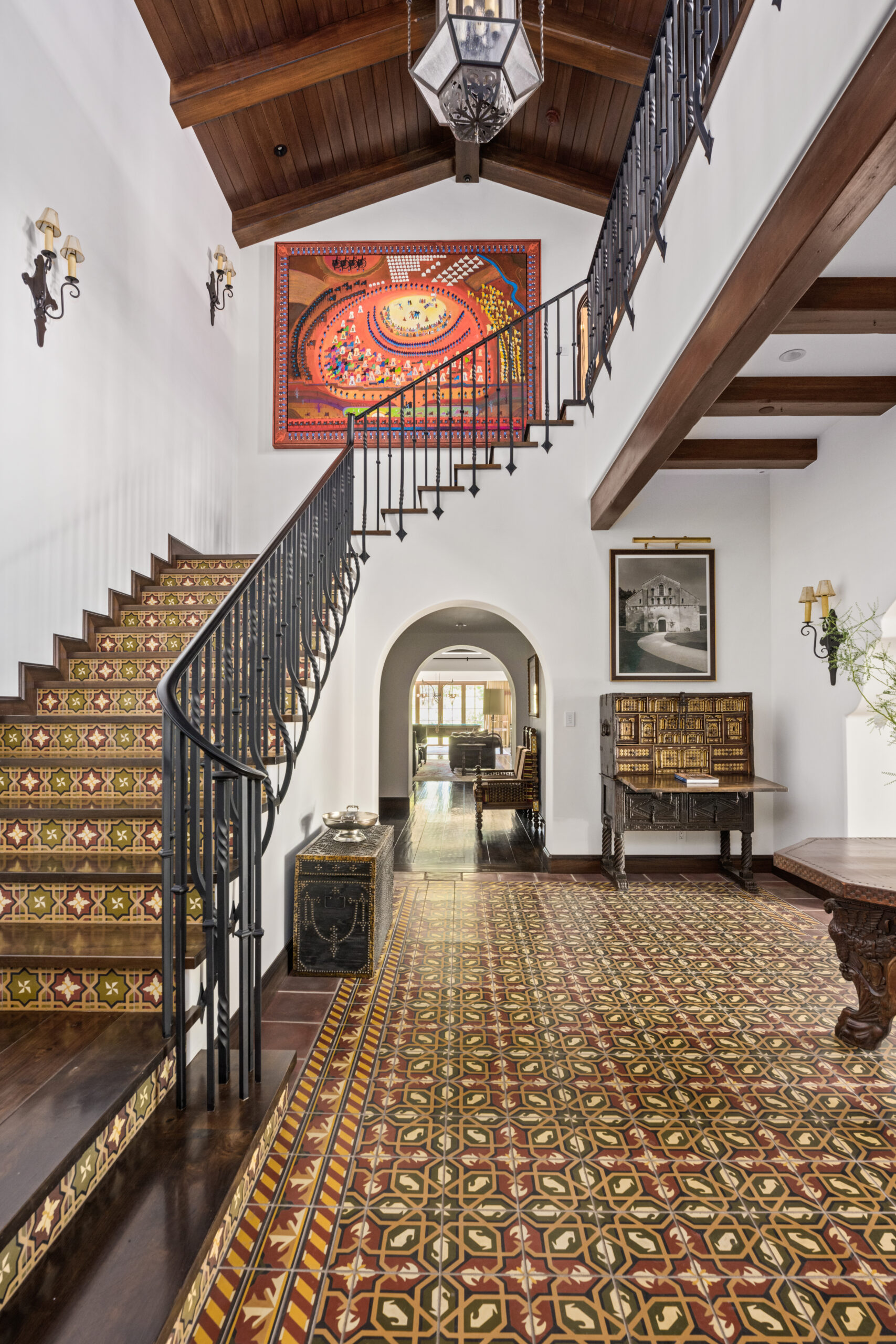 Entry hall remodel with patterned tile flooring, arched openings, and exposed beams at Santa Barbara Estate