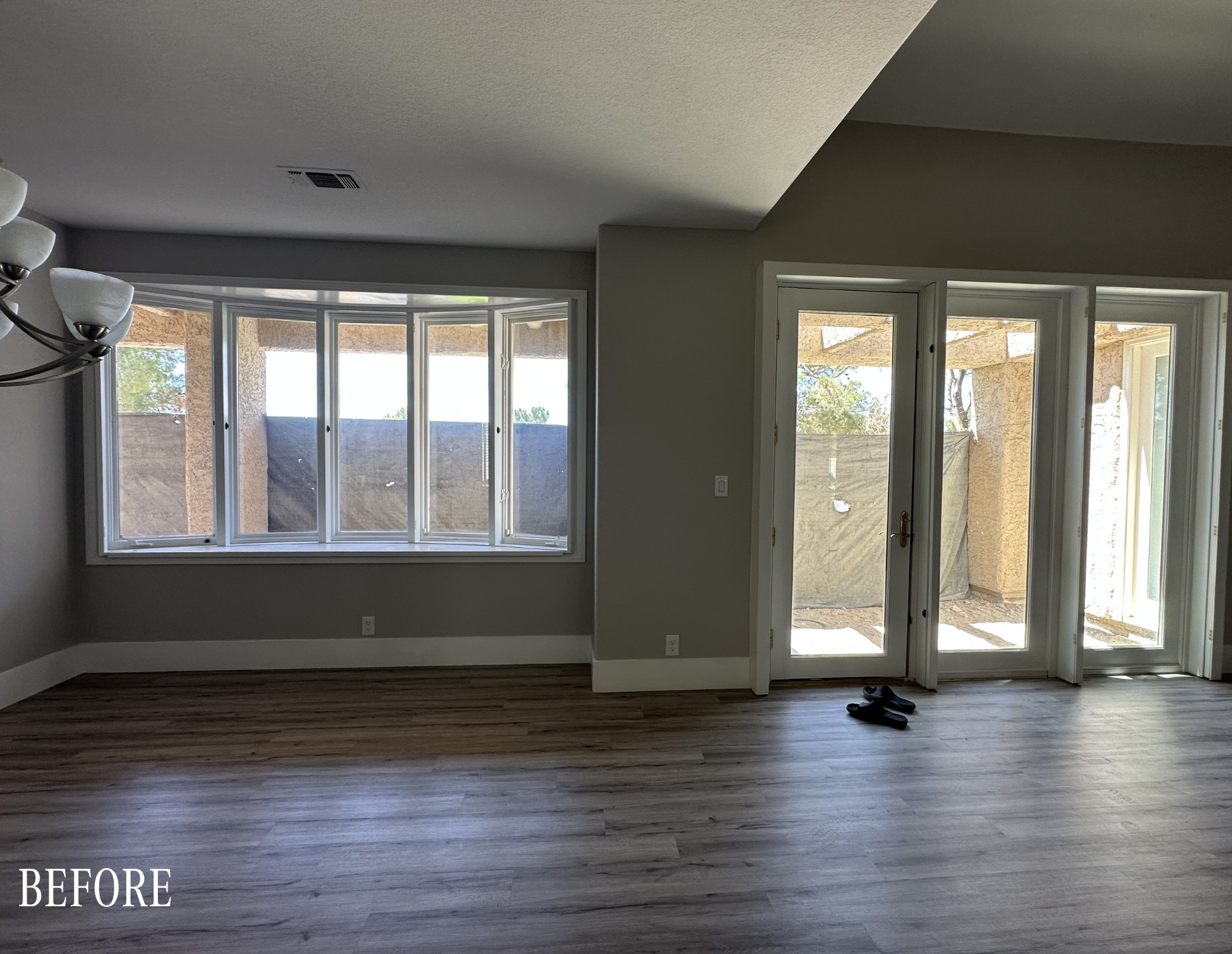 Before: Original 1988 kitchen with dated louvered cabinetry, carpet flooring, and recessed lighting in The Parker Spanish Trails