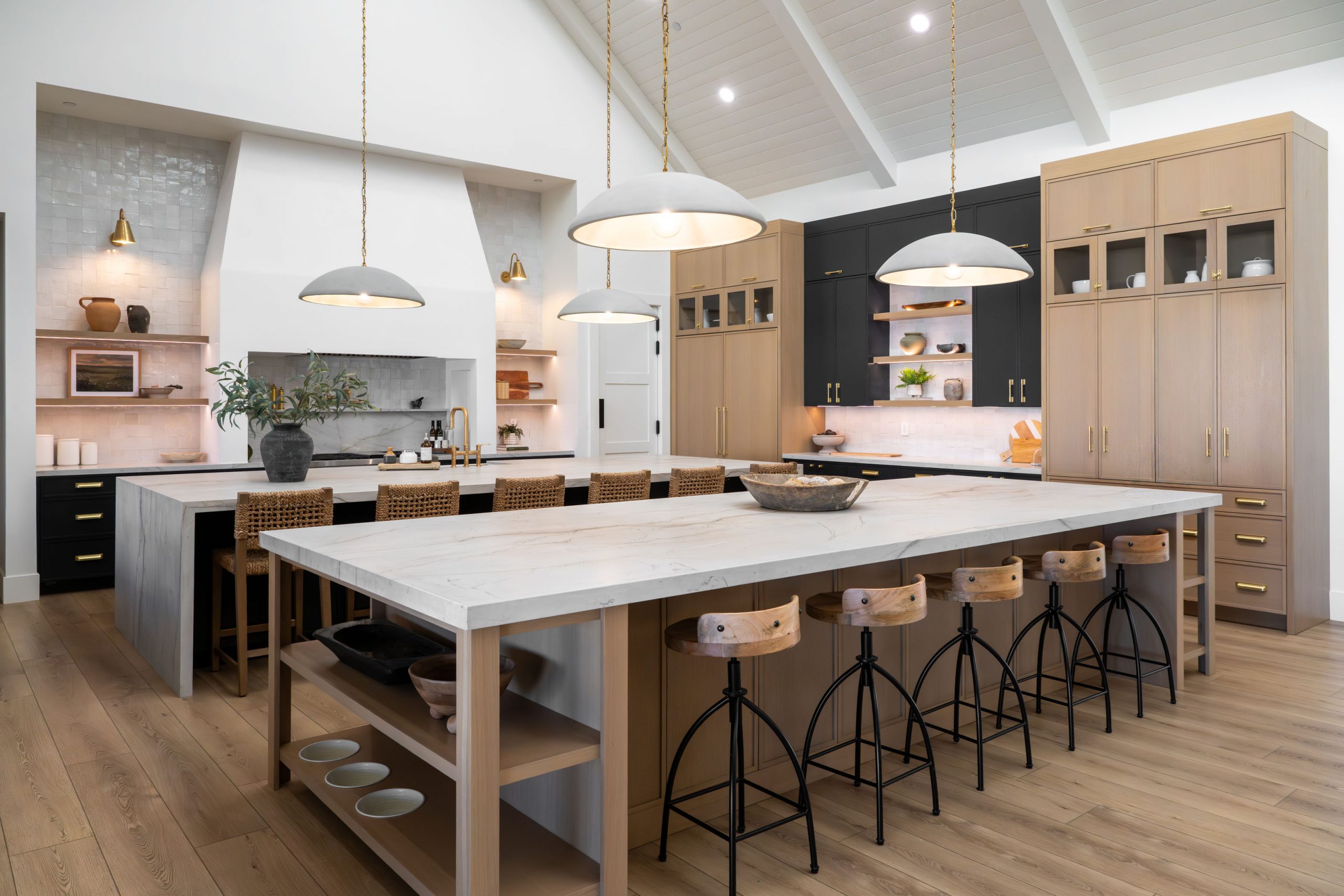 This modern farmhouse built and designed by Kingdom & Co. is one of four custom homes that Kingdom & Co. built in this community. Featuring a cupola this custom kitchen can seat up to 16 people comfortably with the double island