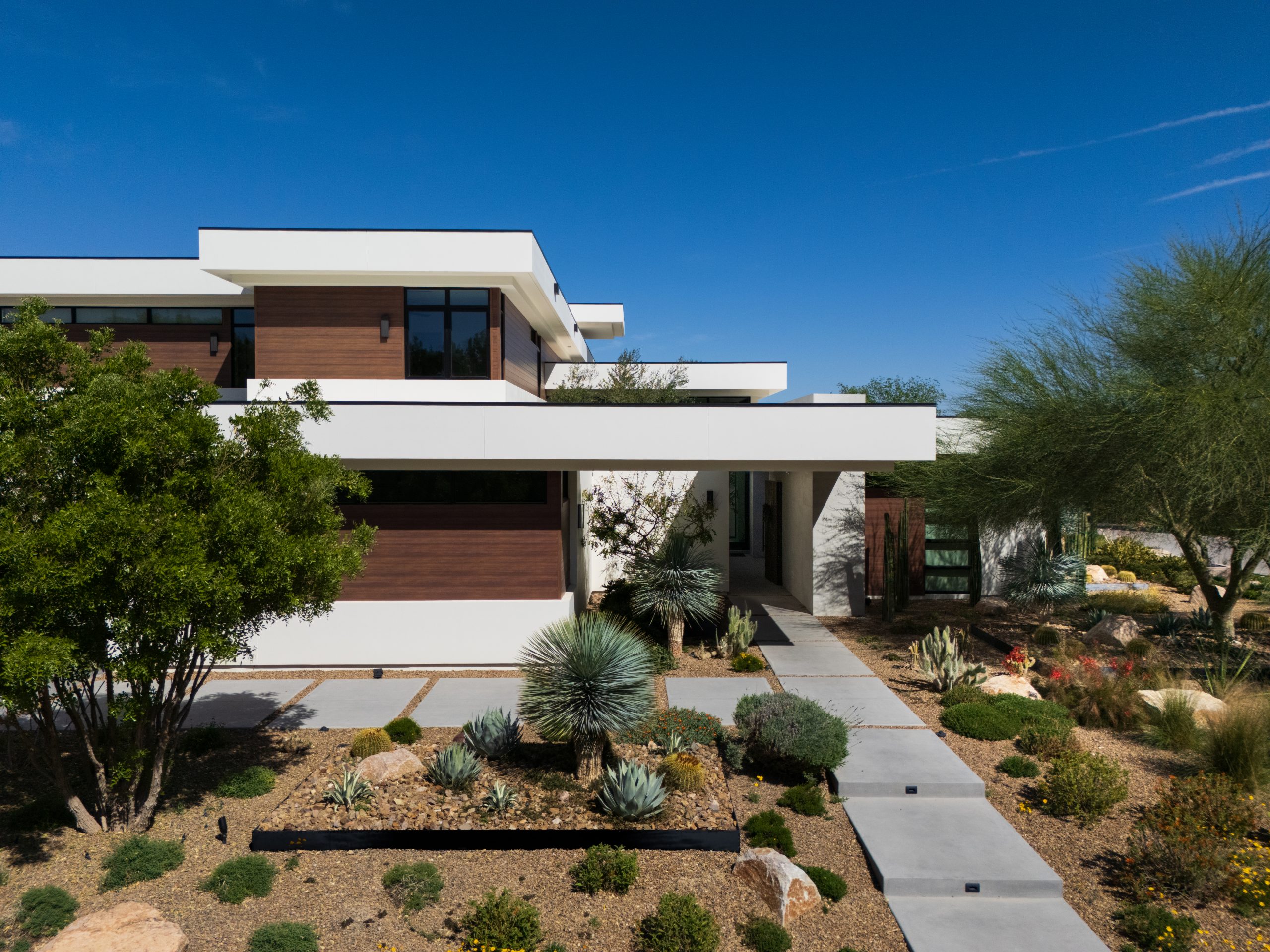 This desert modern custom home built in Las Vegas by John McDonough with Kingdom & Co. is located in Centennial Hills. This custom home has architectural components that supports and enhances the surrounding landscape.