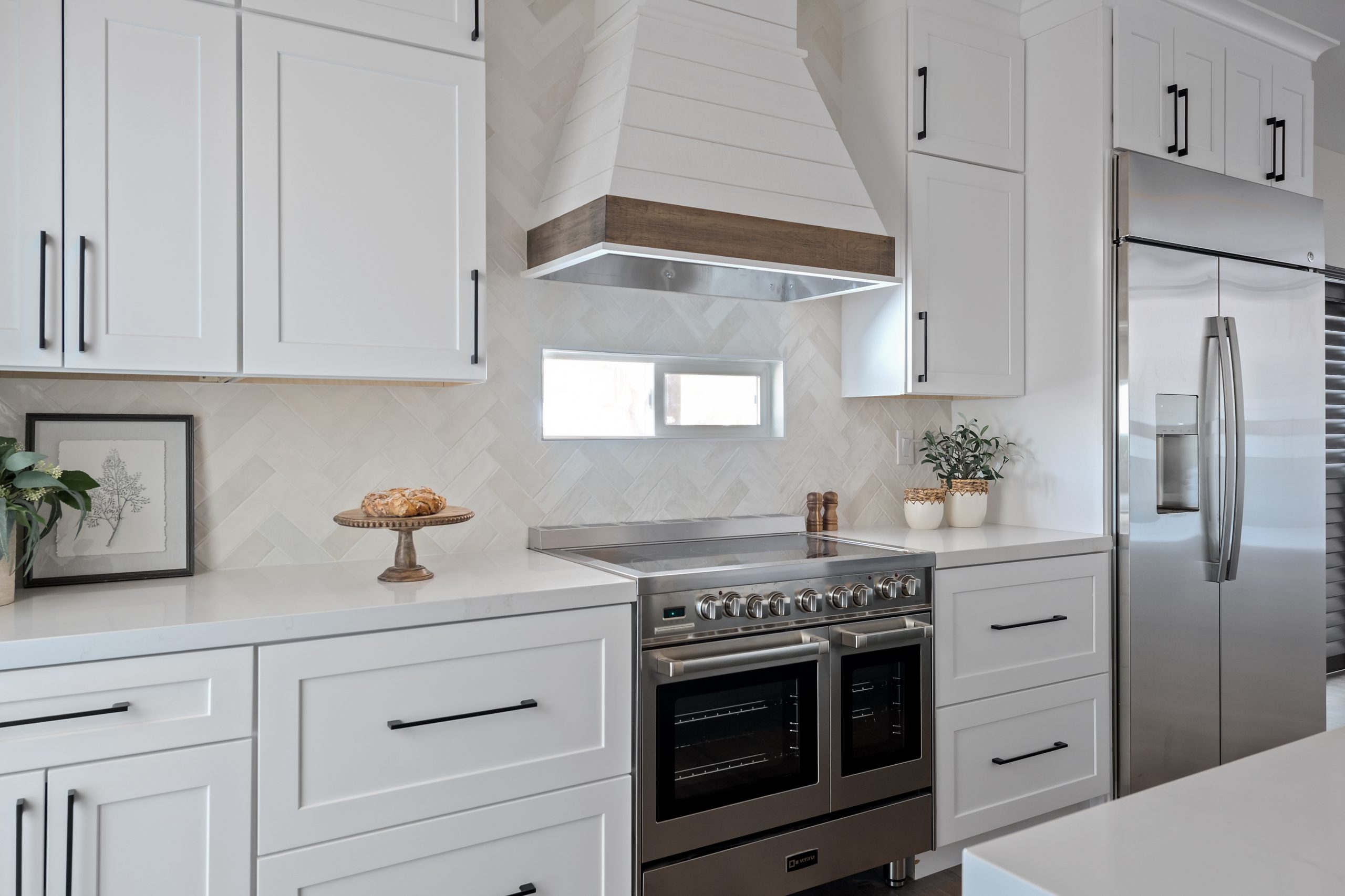 Centennial Hills kitchen after remodel by Kingdom & Co., new oven and hood range 
