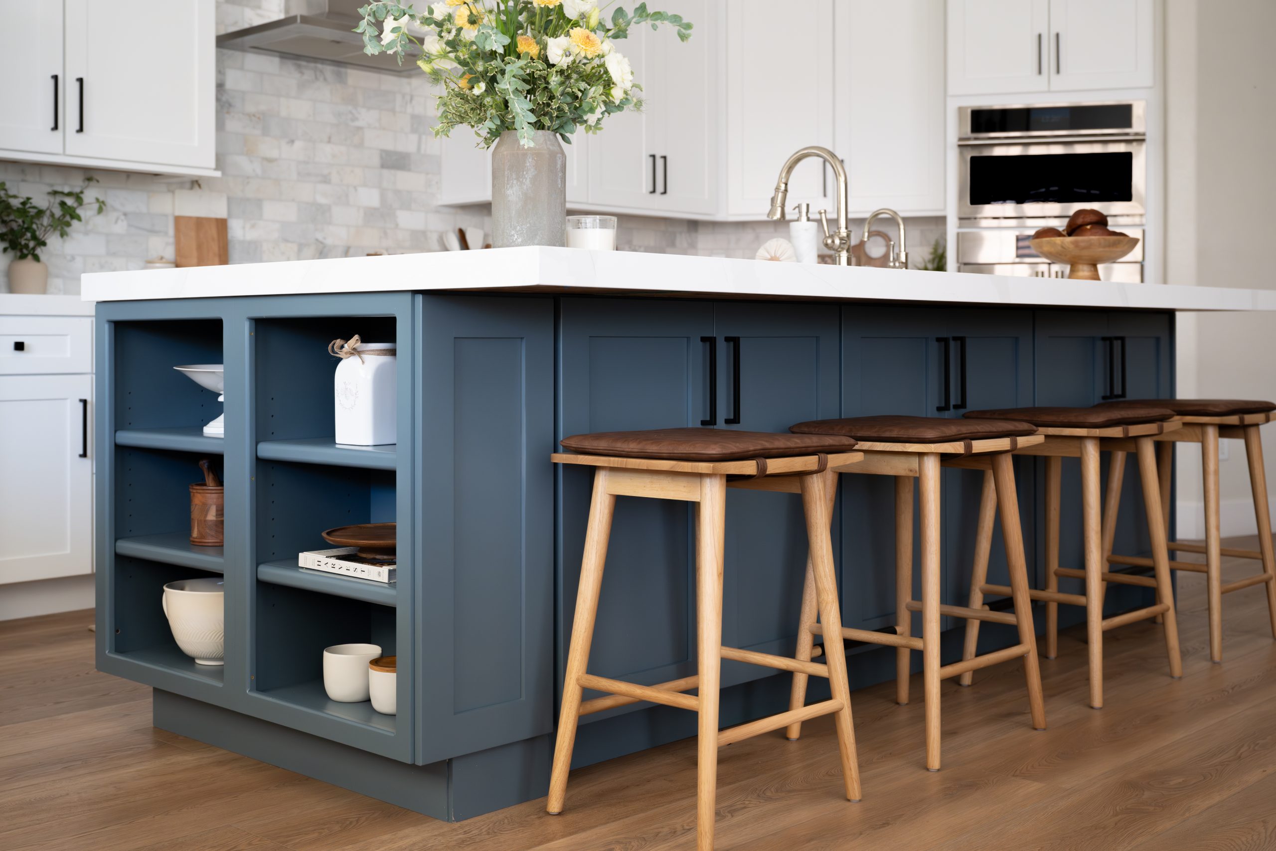 The Vistas Summerlin kitchen after small luxury remodel by Kingdom & Co., navy island and marble counters