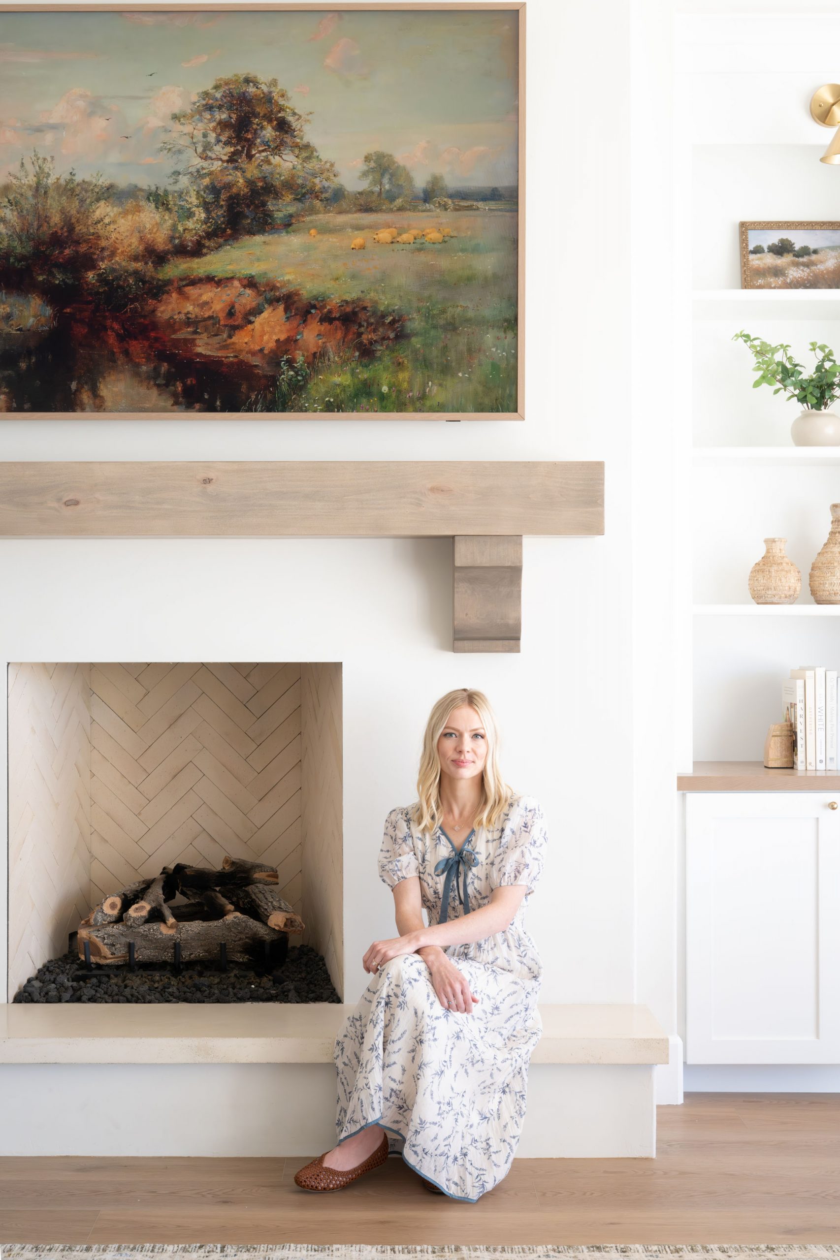 White Gables Estate027 Great room fireplace detail with herringbone firebox interior, reclaimed wood beam mantel, and original landscape painting — The White Gables Estate by Kingdom & Co.