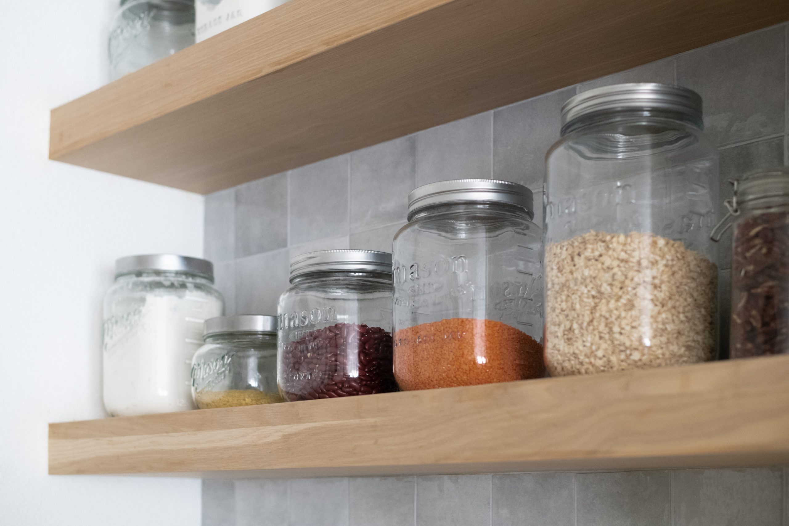 Light wood open shelving with grey tile, Providence kitchen remodel