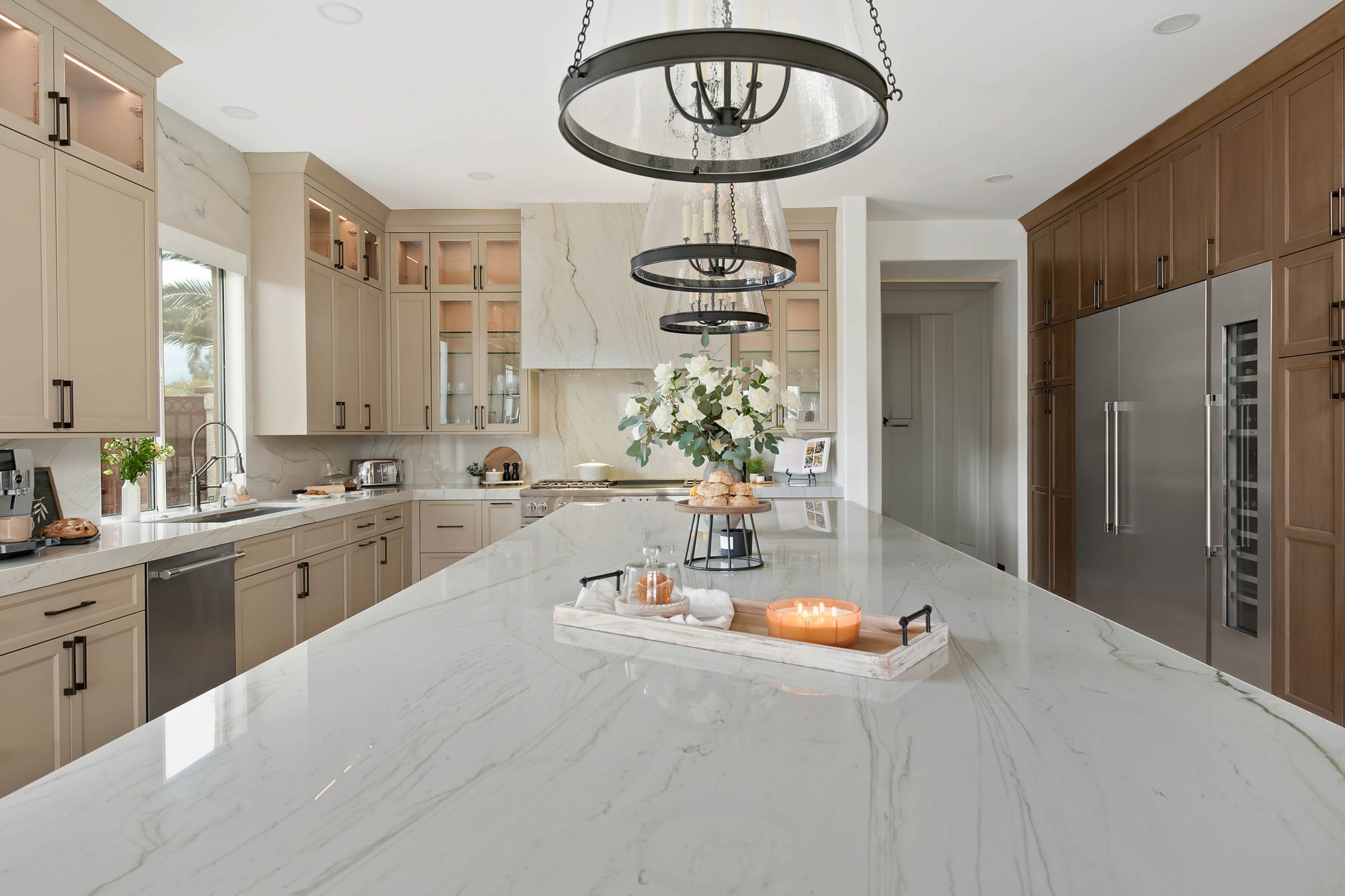 The Volere_11 Centennial Hills kitchen after remodel by Kingdom & Co., new oven and hood range