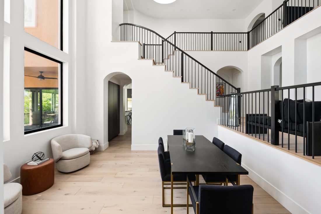 The entry way of a luxury home, with a modern, minimalist staircase.