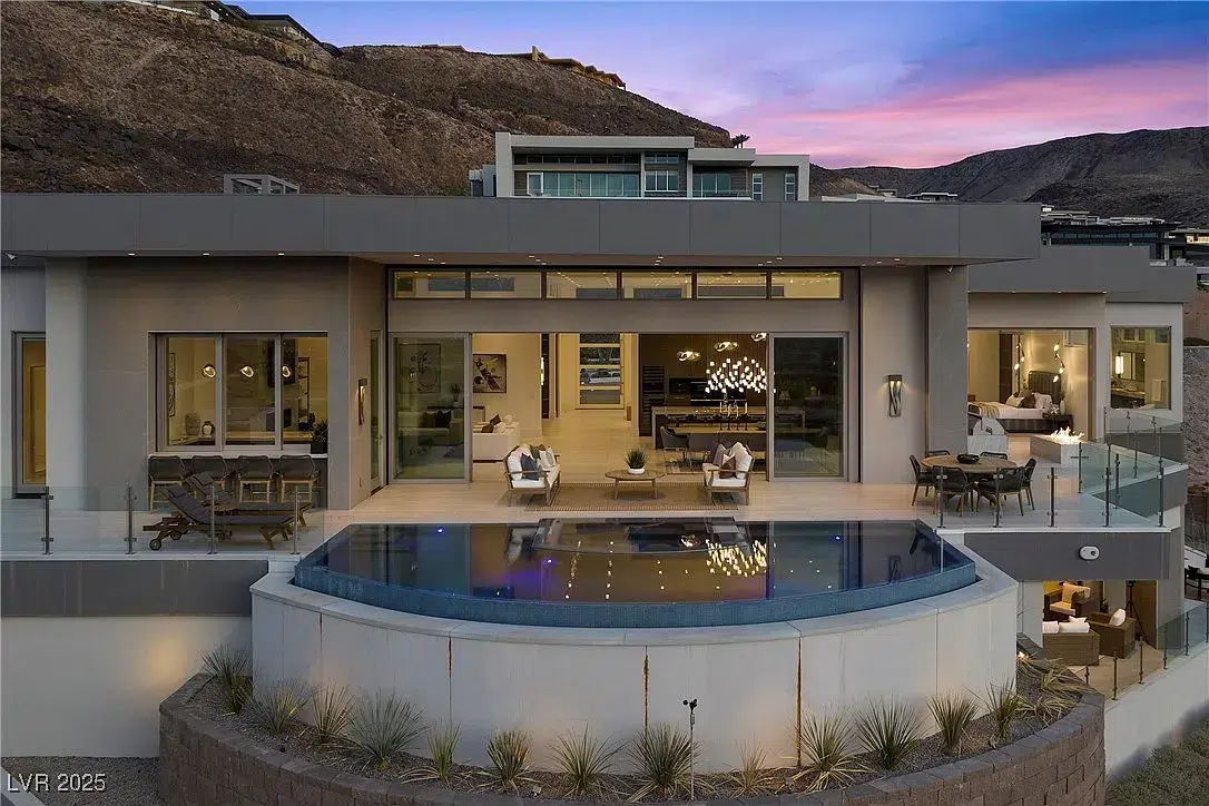 This custom luxury new build in Las Vegas, by John McDonough with Kingdom & Co. is located in MacDonald Highlands. Built with retaining walls etched into the side of the mountain to allow for the best views for the property.