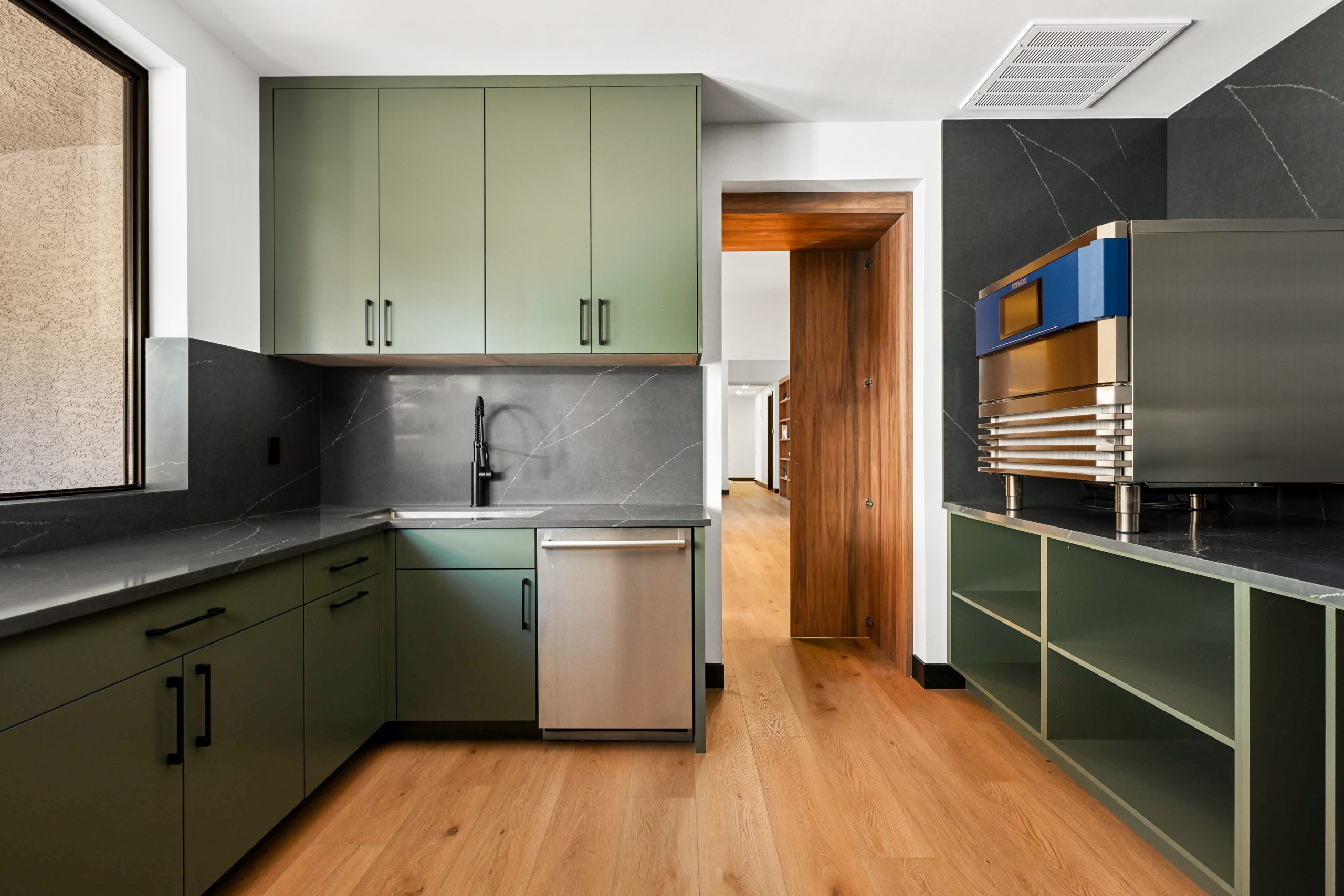 Sage green prep kitchen with Irinox blast chiller and black soapstone counters, Kingdom & Co. The Lakes remodel.