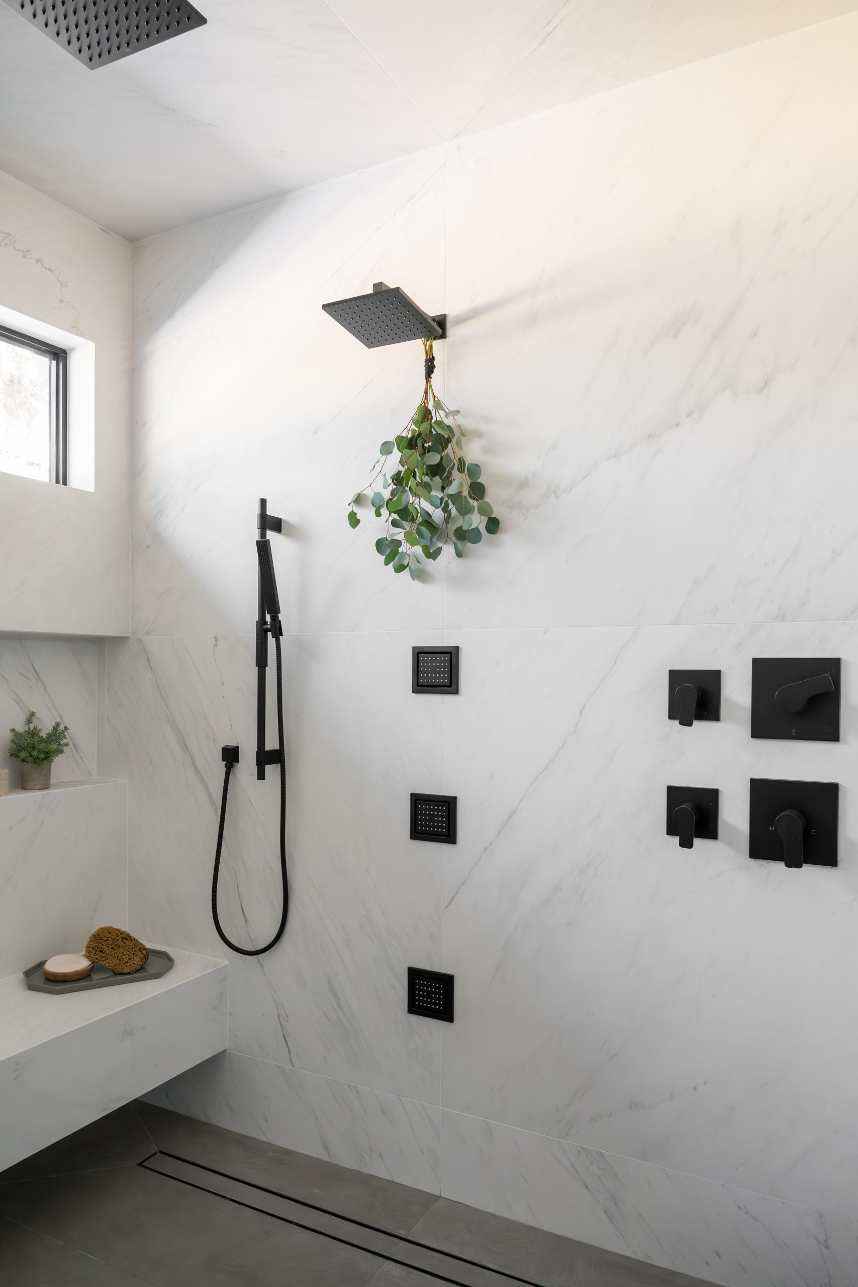 Primary spa shower detail with black rain head, hand shower, and thermostatic controls, Kingdom & Co. The Lakes.