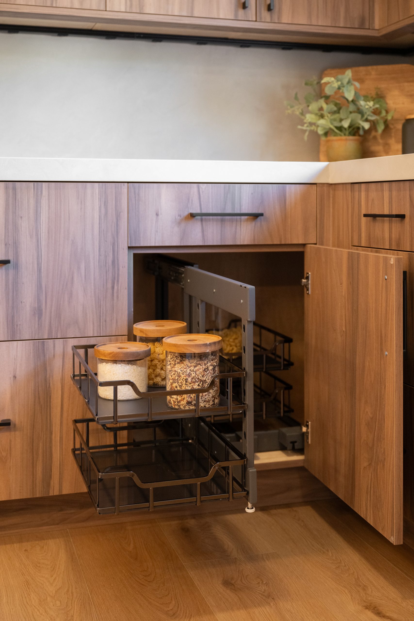 Corner cabinet swing-out pull-out with wire baskets and glass canisters, Kingdom & Co. The Lakes kitchen storage.
