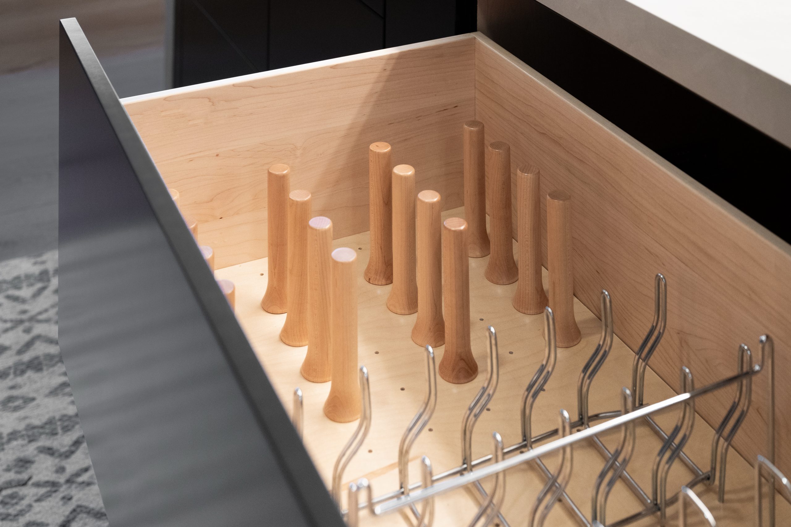 Custom pot storage drawer with maple peg dividers and dish rack, Kingdom & Co. The Lakes kitchen detail.