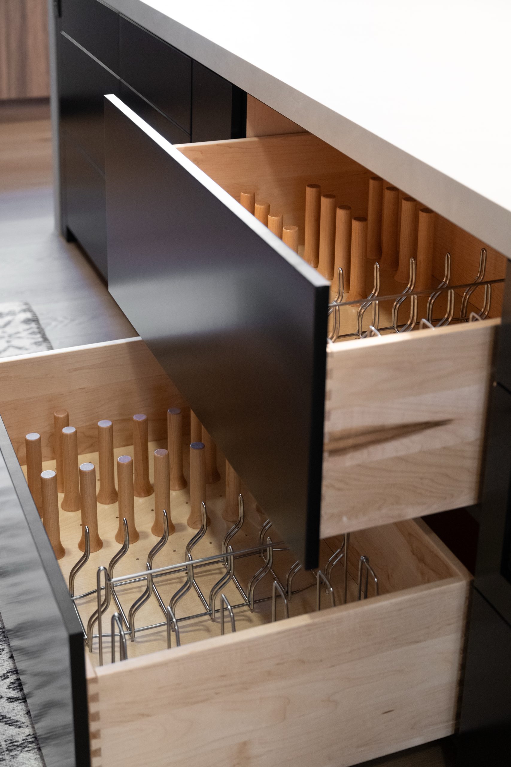 Stacked custom pot and pan drawers with maple peg dividers, Kingdom & Co. The Lakes kitchen storage detail.