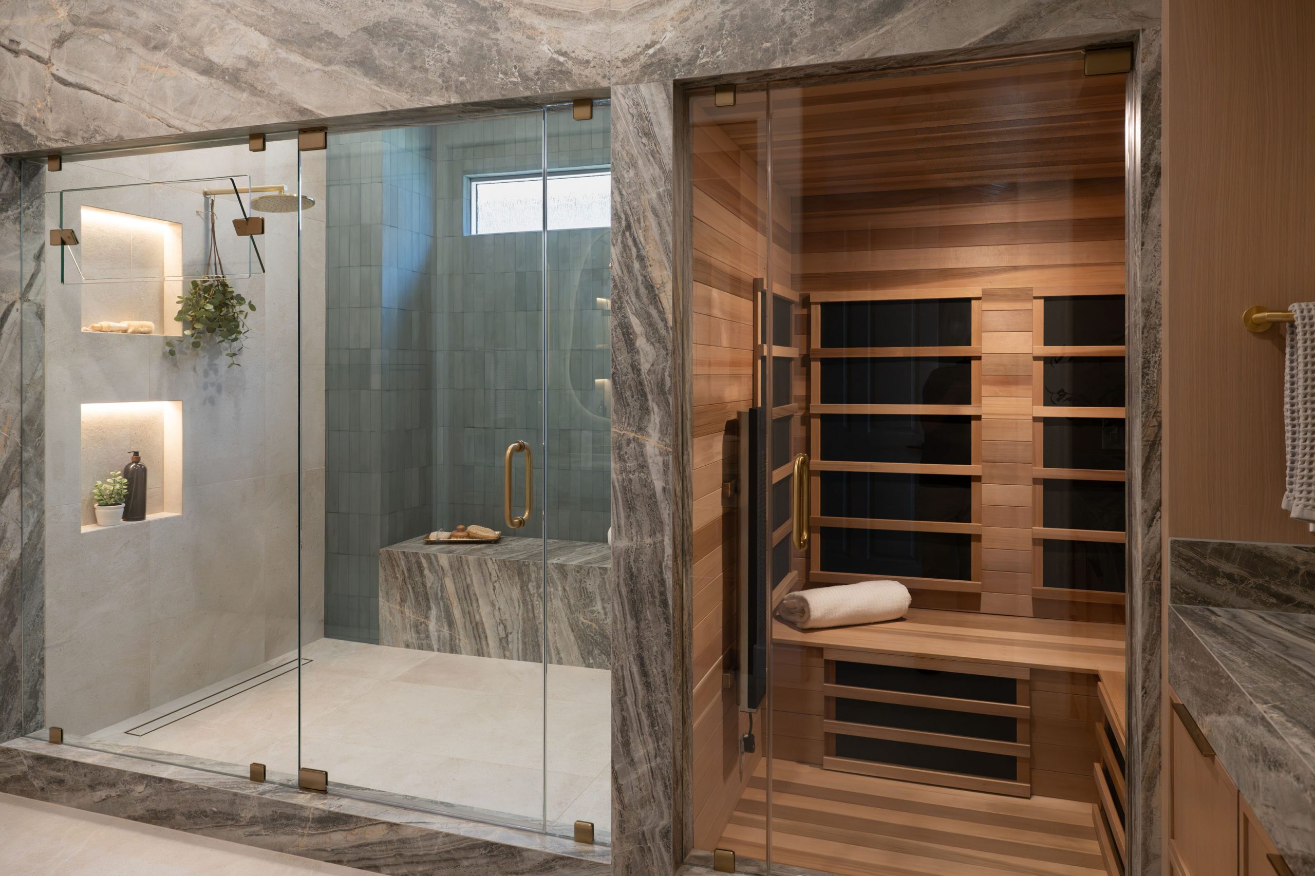 Wide view of stone shower and cedar sauna in primary bath, Kingdom & Co. Summerlin remodel.