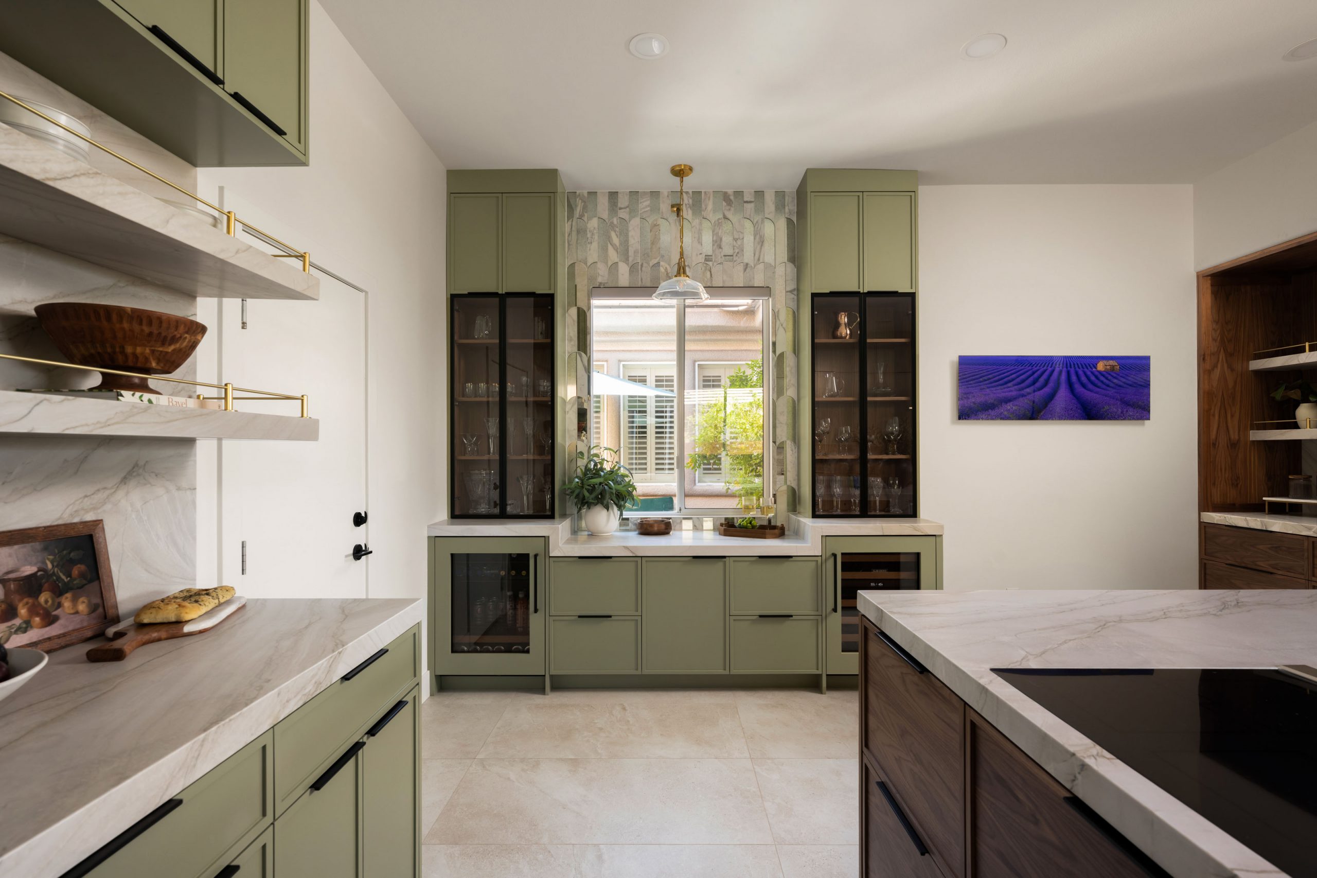 the-astoria_summerlinremodel Sage green wet bar with tall glass-front cabinets, arched tile, and dual beverage coolers, Kingdom & Co.