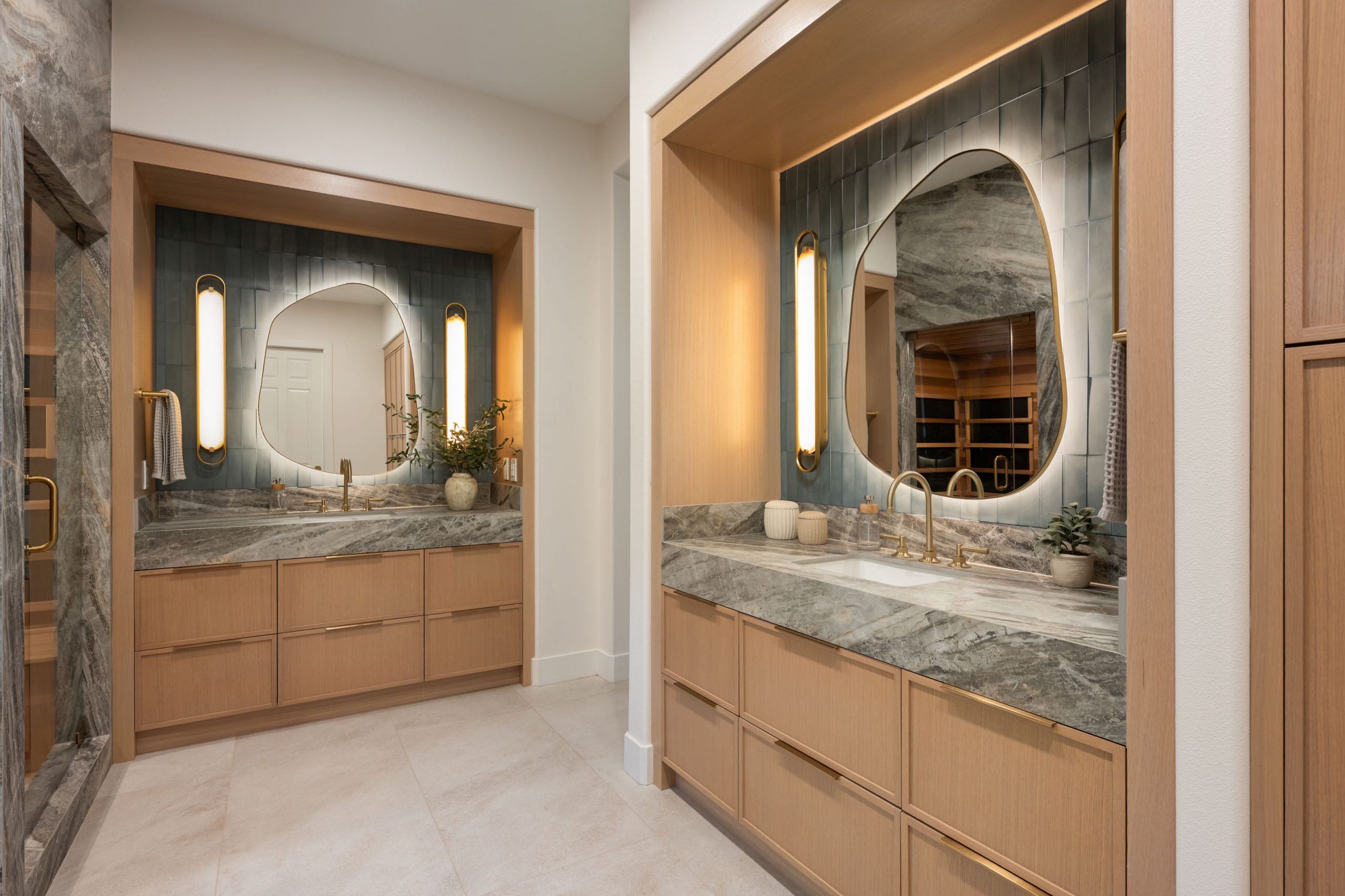 The Astoria_SummerlinRemodel His-and-hers white oak vanities with organic backlit mirrors, Kingdom & Co. Summerlin primary bath.