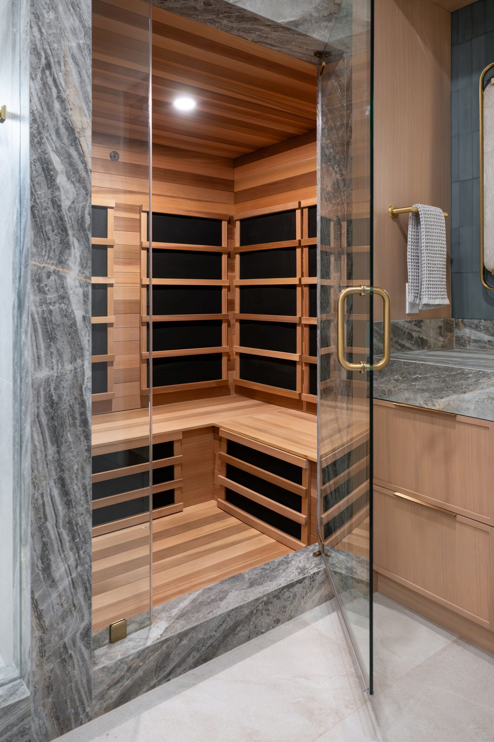 Cedar infrared sauna interior with corner bench, Kingdom & Co. Summerlin primary bath remodel.