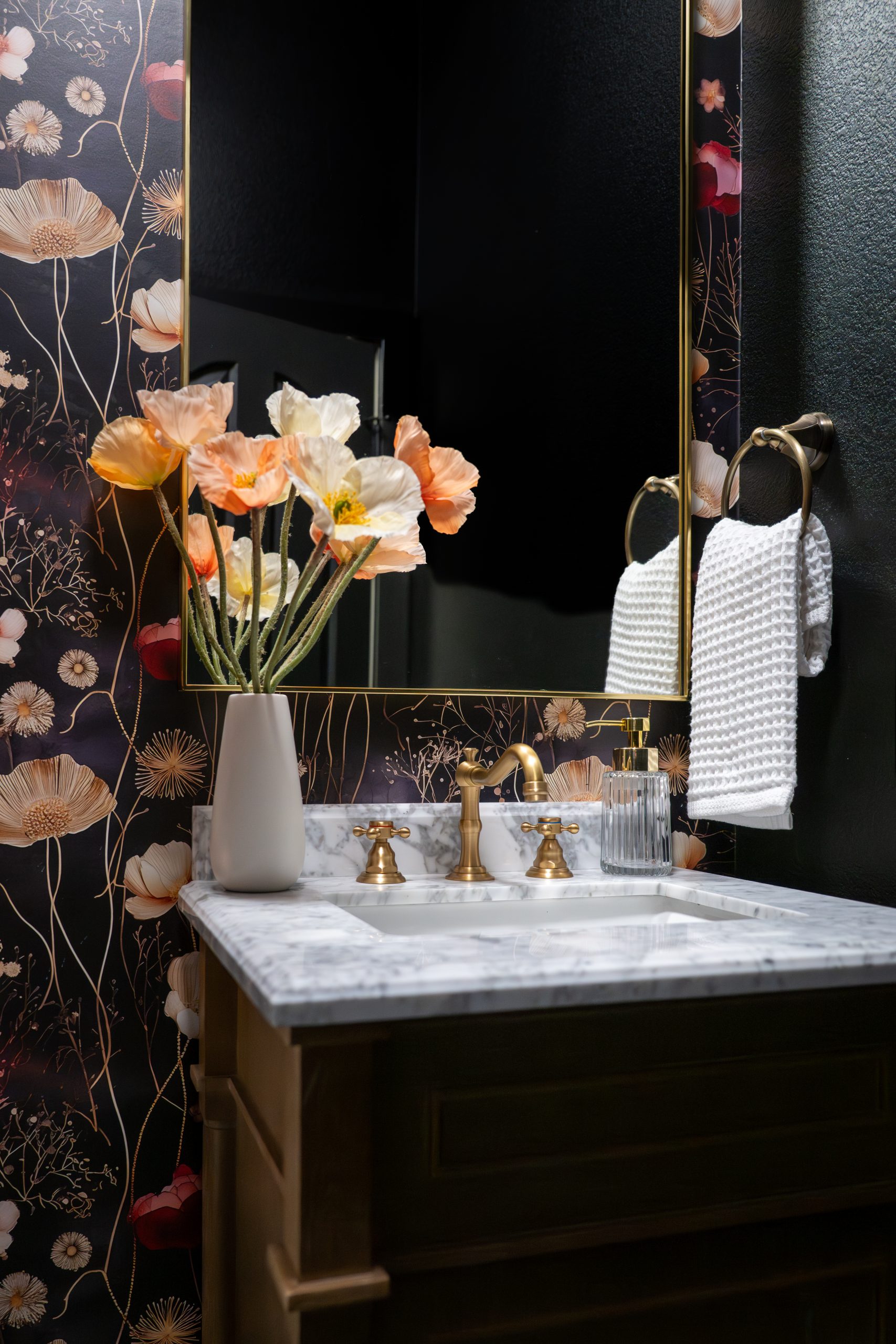 the-hearthstone-the-lakes-bathroom-remodel-kingdom-co Powder room with dark poppy wallpaper, brass framed mirror, and Carrara vanity, Kingdom & Co. The Lakes remodel.