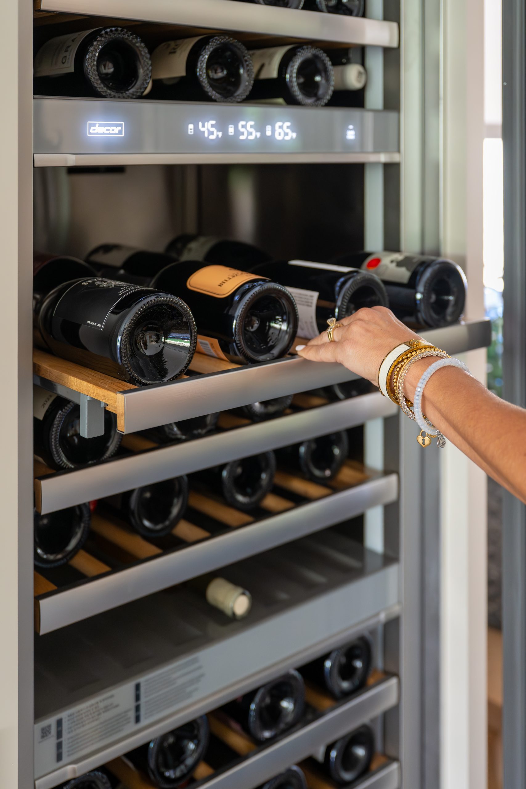 Detail of Dacor three-zone wine column with bottle drawer pulled out, Kingdom & Co. The Lakes dry bar.